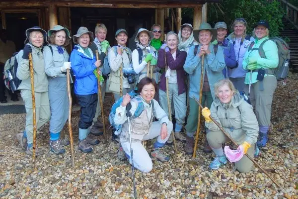 What to Pack for Gorilla Trekking Uganda 2025: The Complete Packing List — Tribes Gorilla Trekking Tours 1 trekker with porter Bwindi Impenetrable Forest Uganda